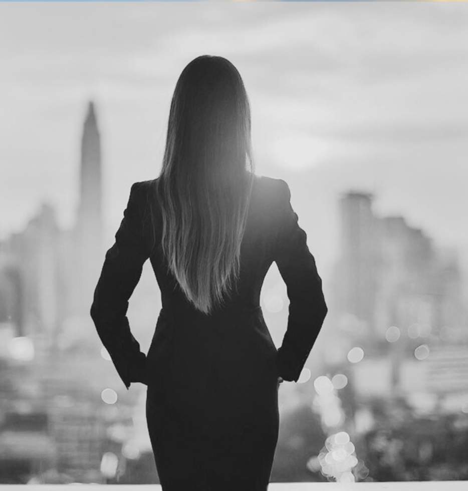 home page, woman looking out her office window